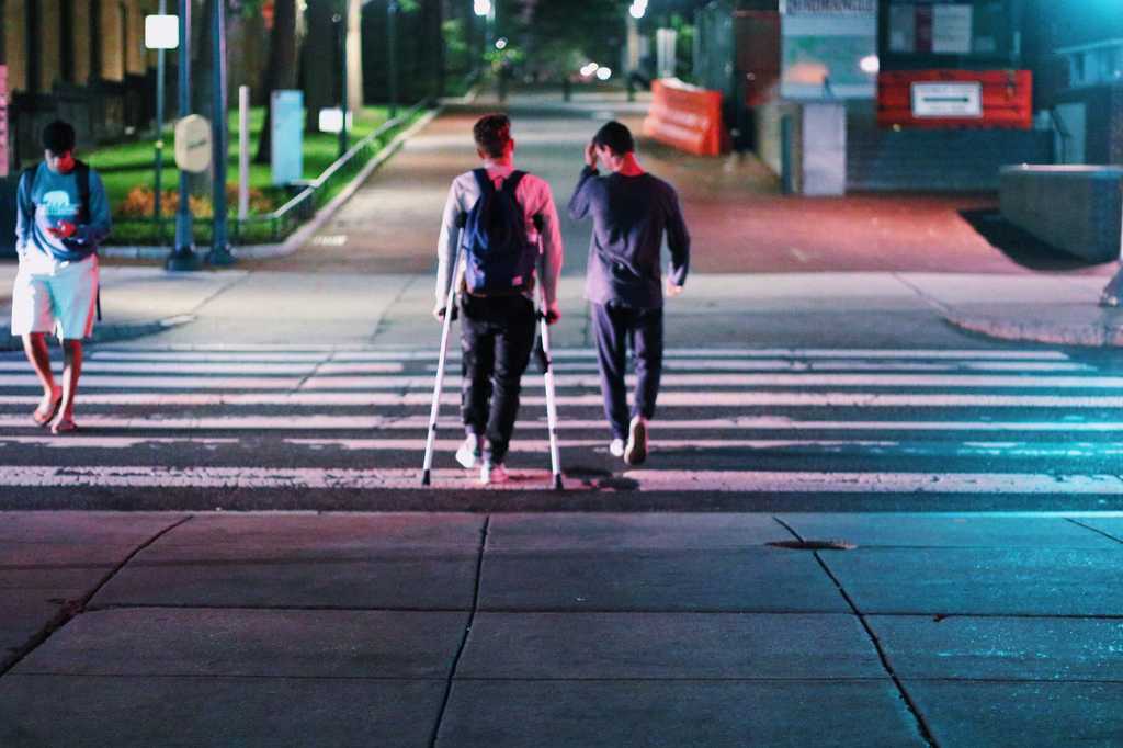 Me crutching and my friend Daniel walking across campus my Freshman year